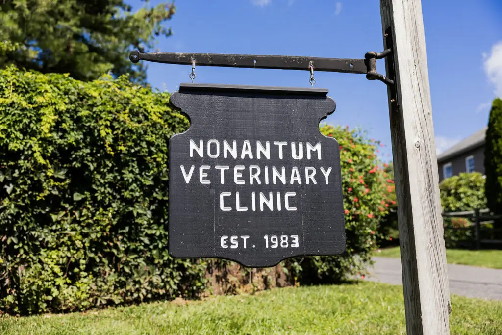 A wooden sign hangs outside Nonantum Veterinary Clinic, established 1983